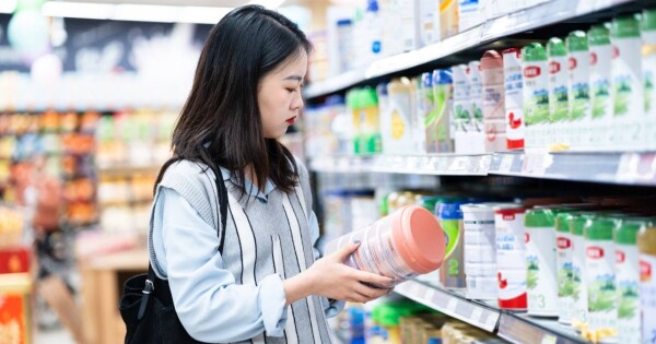 Mulher escolhendo produto em mercado